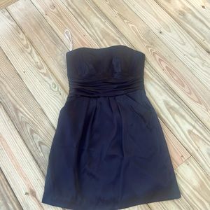 Black David’s Bridal cocktail dress with pockets.